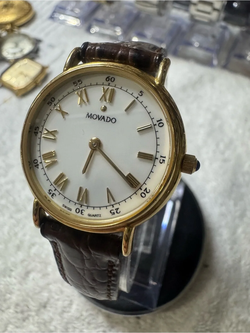 #120 Movado Gold Tone Case White Dial Watch with Brown Leather Strap